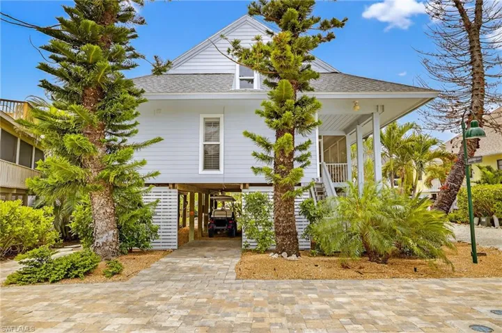 Coastal home with a carport and roof with shingles