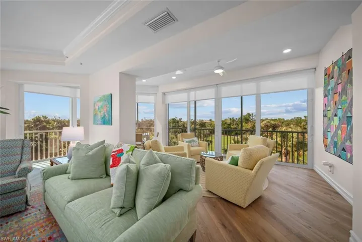 Living room featuring wood-type flooring and ornamental molding
