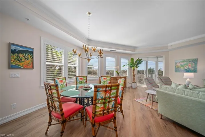 Dining space featuring plenty of natural light, light wood-type flooring, and an inviting chandelier