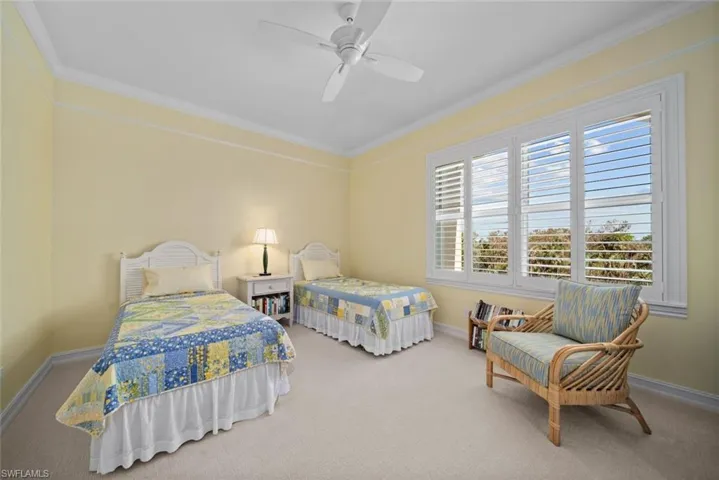 Bedroom featuring ceiling fan, carpet floors, and ornamental molding