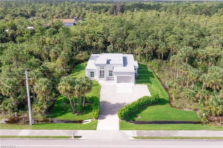 Aerial view featuring a wooded view