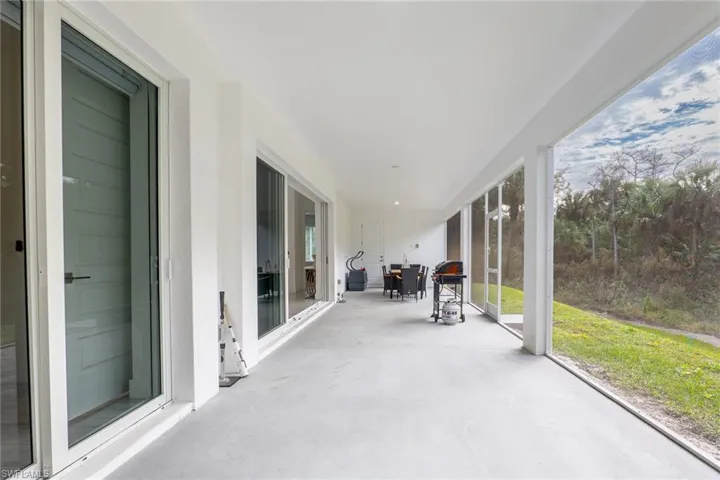 Unfurnished sunroom featuring unfinished concrete floors