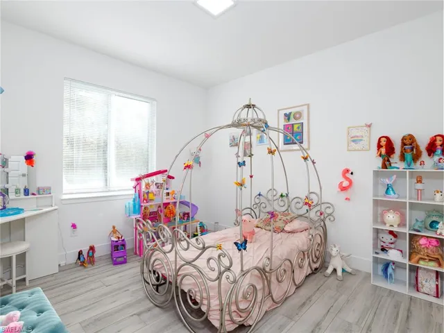 Bedroom featuring baseboards and wood finished floors