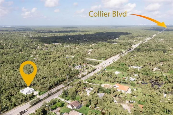 Birds eye view of property featuring a wooded view