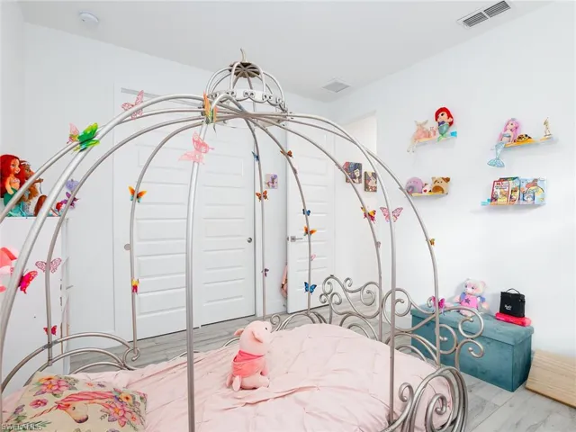 Bedroom featuring visible vents