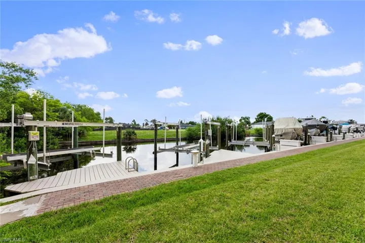 Dock area featuring a yard and a water view