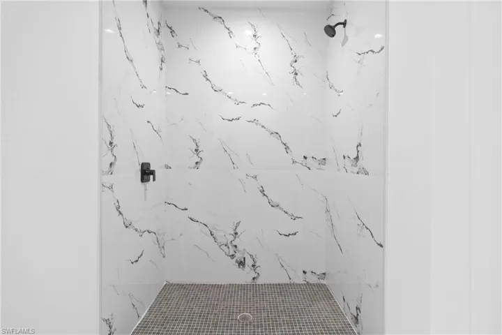 Full bathroom featuring a marble finish shower