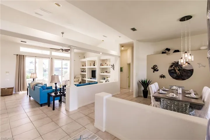 Tiled living room featuring ceiling fan