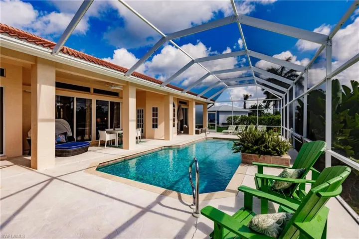 View of swimming pool featuring a lanai, ceiling fan, and a patio