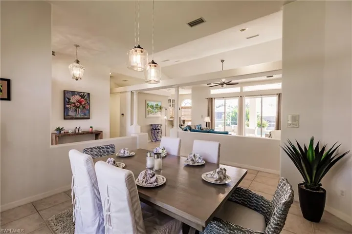 Tiled dining space featuring ceiling fan