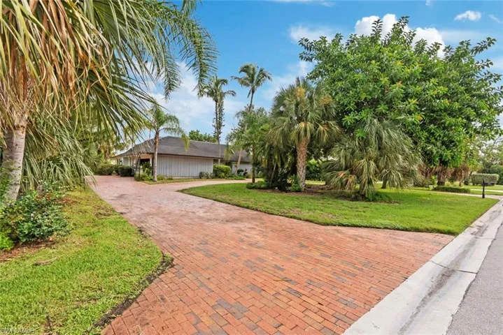 View of property featuring a lawn