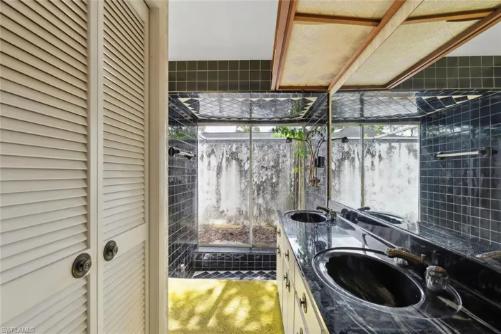 Bathroom with a wealth of natural light and vanity