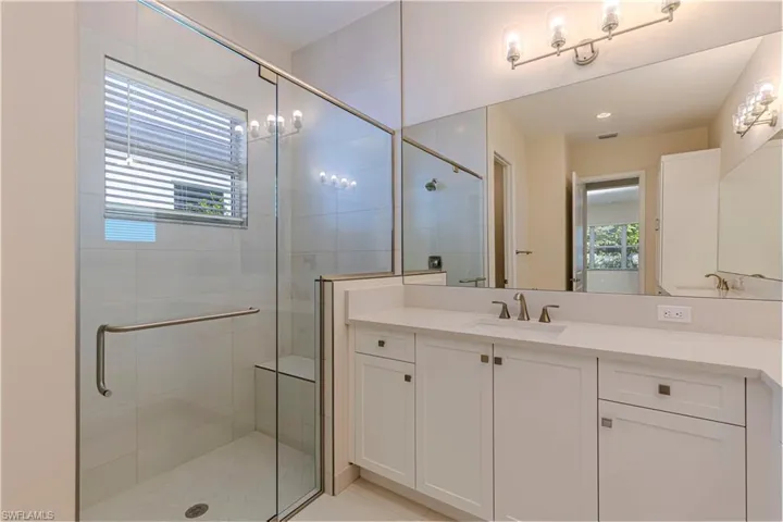 Bathroom featuring vanity and a stall shower