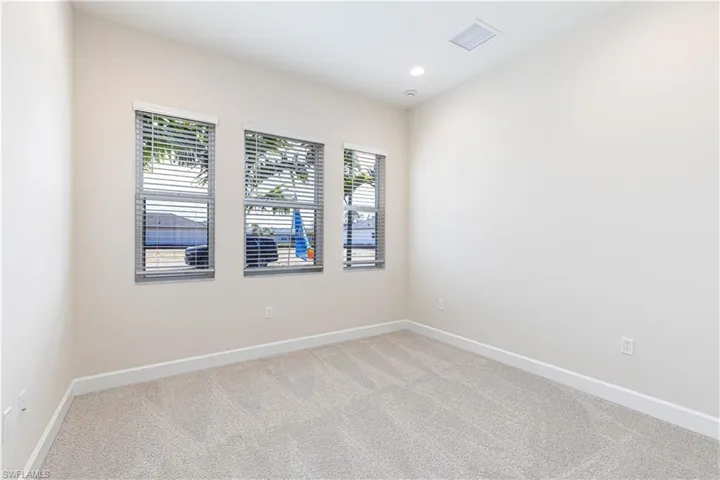Unfurnished room with light carpet and recessed lighting
