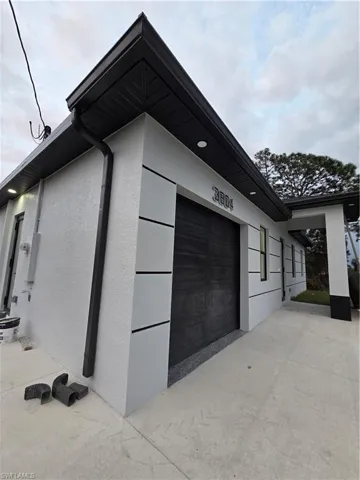 View of property exterior featuring stucco siding and a garage