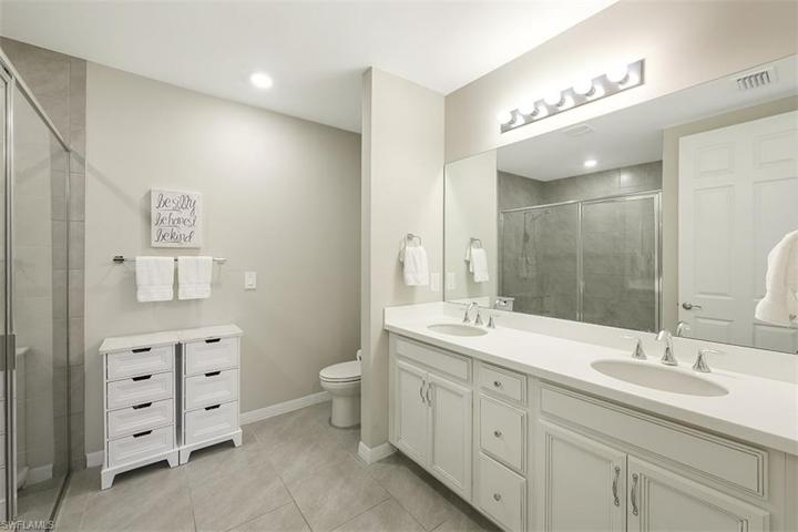 Master bathroom includes dual sinks as well was large walk-in shower.
