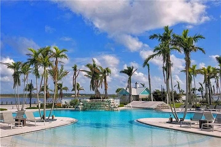 Resort style amenities at Naples Reserve include picturesque Eagle Lake, a lagoon-shaped pool with lap lanes, restaurant and poolside tiki bar, pickleball, tennis, fully equipped gym, bocce ball, dog parks, and walking trails.