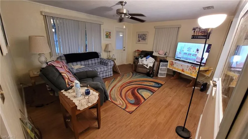 Living room with hardwood / wood-style flooring and ceiling fan