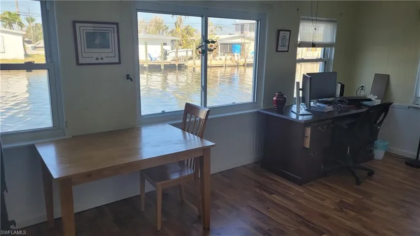 Office area with dark wood-type flooring