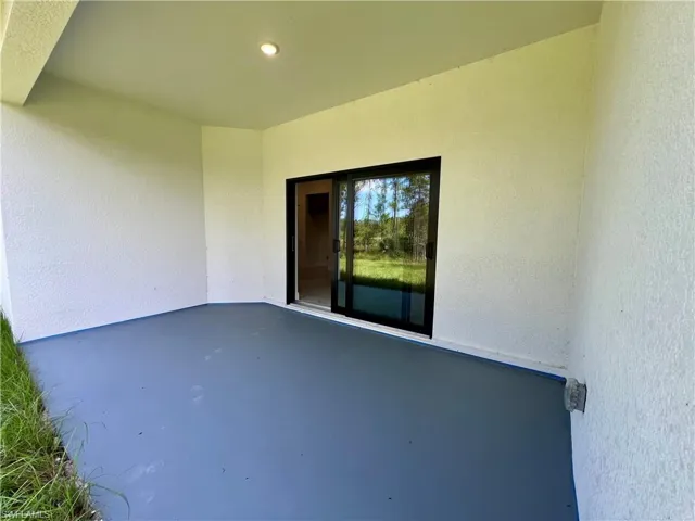 Covered porch in rear overlooking the backyard.