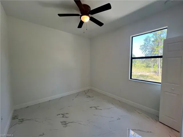 Guest bedroom with plenty of natural light and ceiling fan