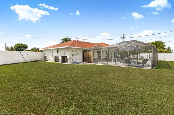 Back of property with a patio, a fenced backyard, a sunroom, and a lanai