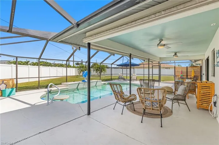 View of swimming pool with a sunroom, a lanai, a patio, and a fenced backyard