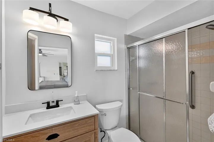 Full bathroom featuring a shower stall and vanity