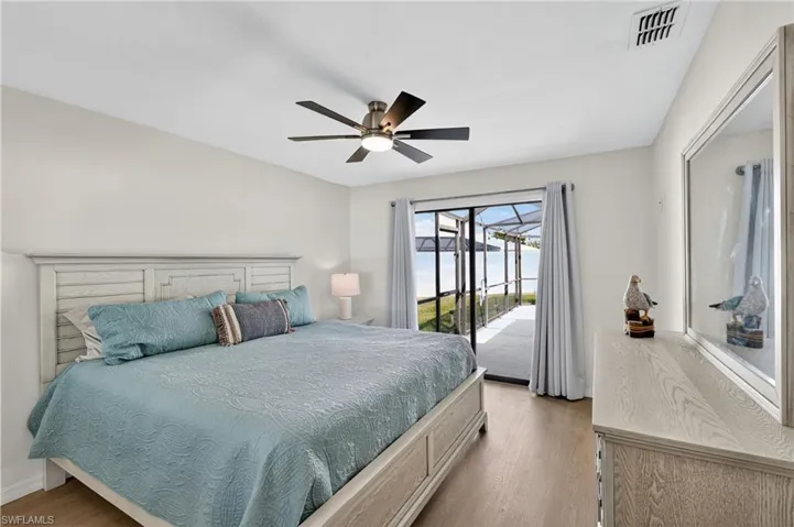Bedroom featuring wood finished floors, access to outside, and ceiling fan