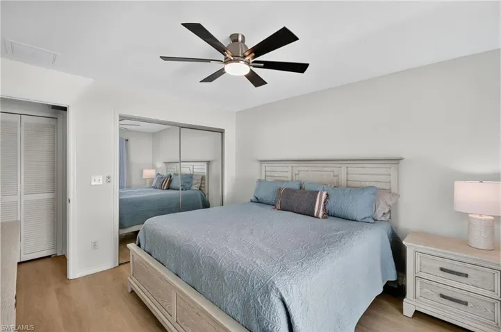 Bedroom featuring light wood-type flooring, a closet, and ceiling fan