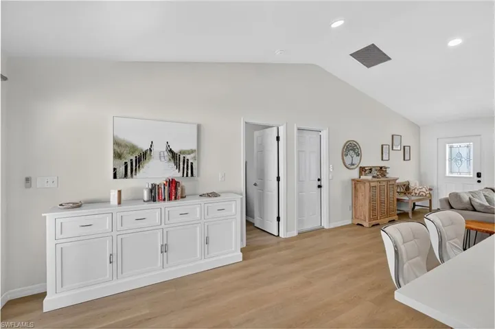 Living area featuring lofted ceiling, recessed lighting, and light wood-style floors