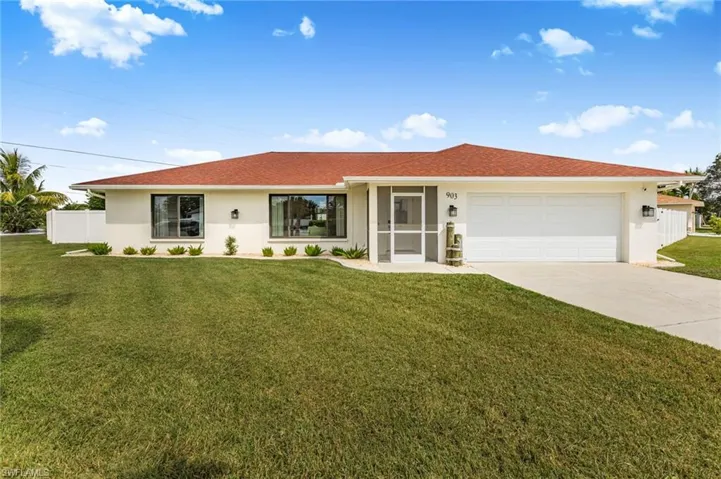 Ranch-style home featuring stucco siding, concrete driveway, and an attached garage