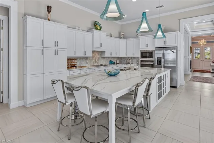 An entertainer's kitchen with an expansive island and abundant storage.
