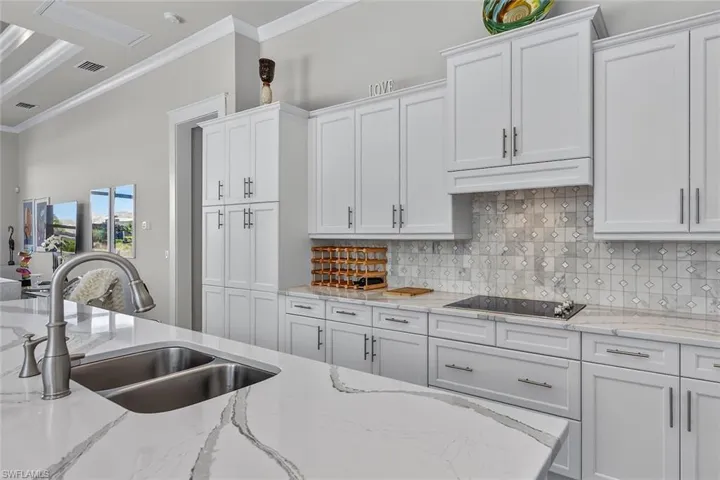 Quartz countertops, custom cabinetry, and generous prep space for everyday living.