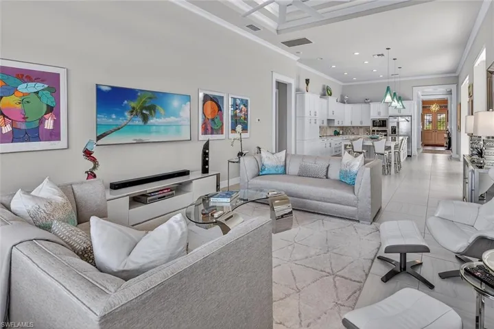 Designed for gathering, this open great room connects beautifully to the gourmet kitchen and lanai.