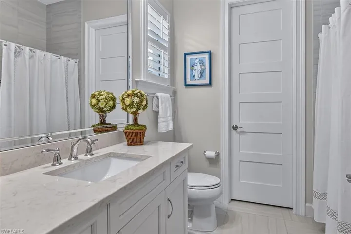 Thoughtfully appointed guest bath with elegant finishes.