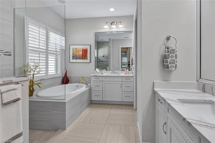 Your private spa retreat featuring a soaking tub, dual vanities, and walk-in shower.