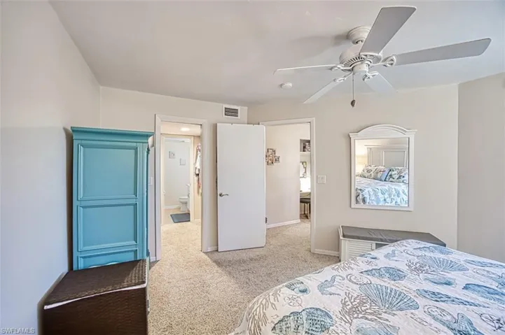Carpeted bedroom with ceiling fan