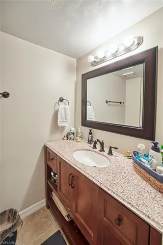 Bathroom with tile patterned floors and vanity