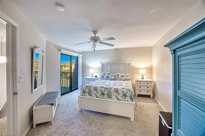 Bedroom with ceiling fan, light colored carpet, and access to outside