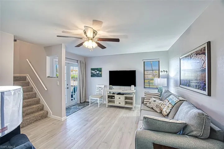 Living room featuring ceiling fan and light hardwood / wood-style flooring
