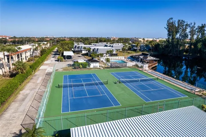 View of sport court with a water view and basketball hoop