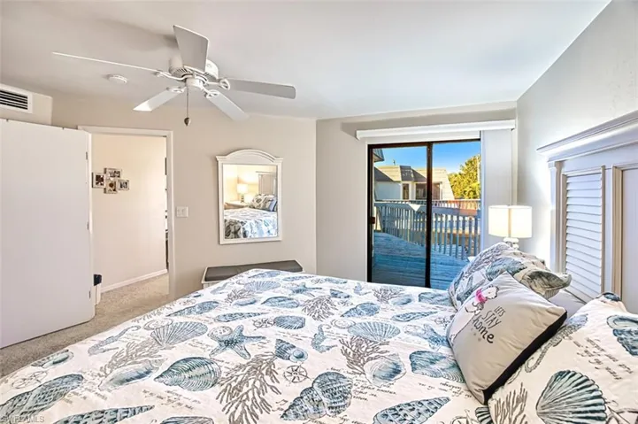 Bedroom featuring access to outside, ceiling fan, and carpet