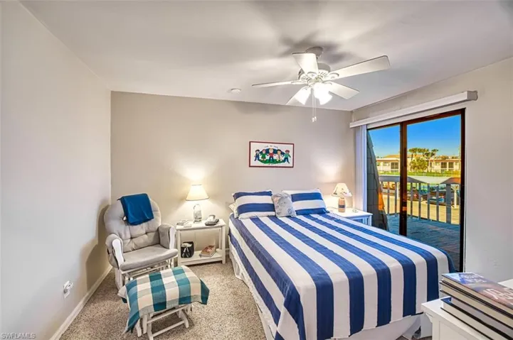 Bedroom with access to outside, ceiling fan, and light colored carpet