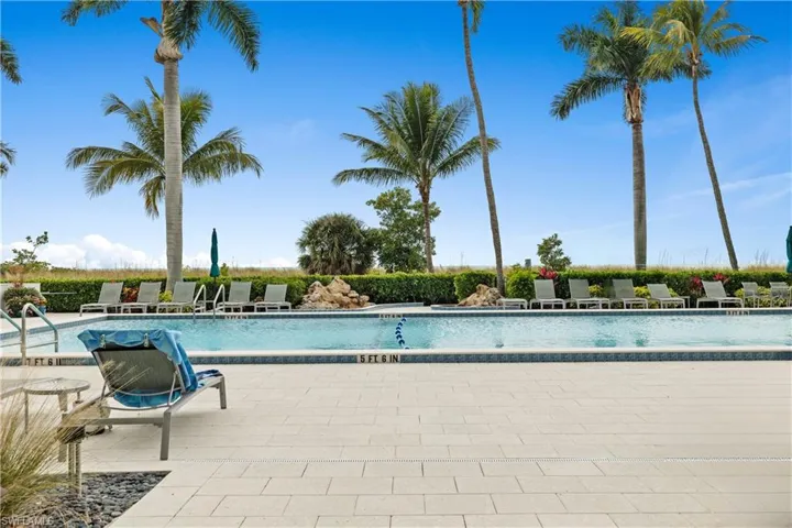 Community pool with a patio