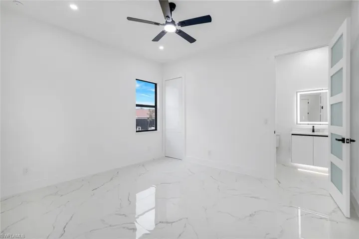 Unfurnished room featuring light marble finish floors, recessed lighting, and a ceiling fan