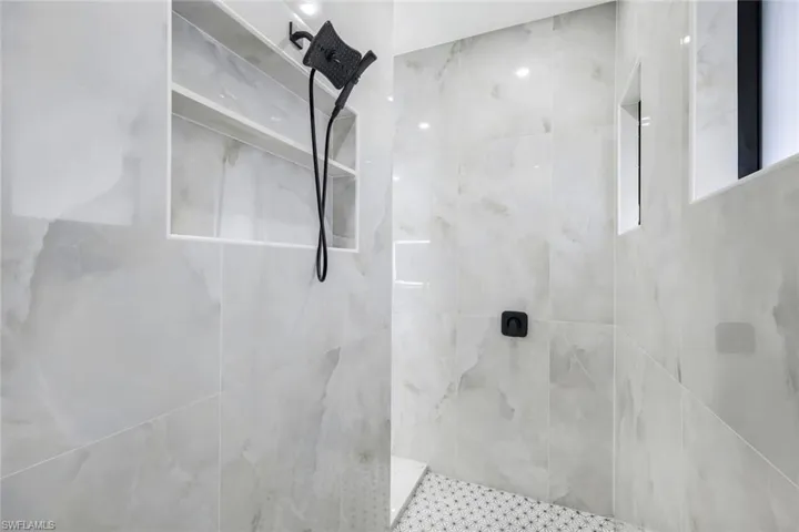 Bathroom with a marble finish shower