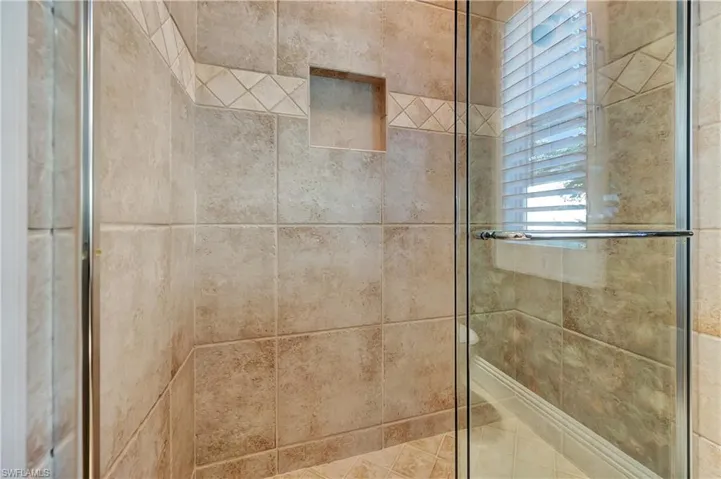 Interior details featuring a shower with shower door