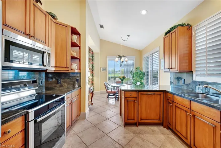 Kitchen with custom cabinets, kitchen peninsula and stainless-steel appliances