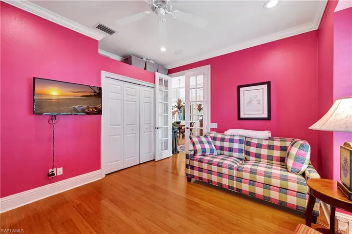 Sitting room featuring hardwood / wood-style flooring, crown molding, and ceiling fan